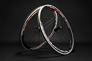 Campagnolo Bullet Ultra 50 carbon fiber road bike wheels on a black studio background